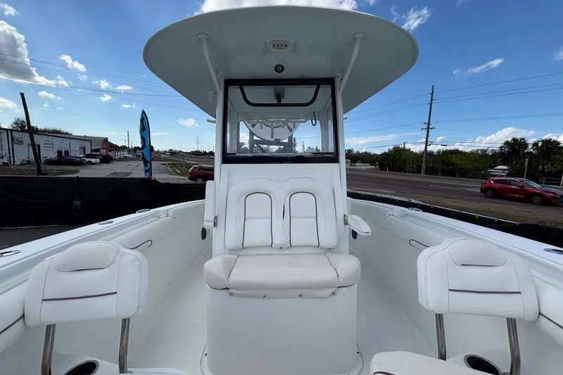 Slide: The Image of 2018 Sea Hunt Gamefish 30 Forward Seating boat with white interior and clear sky background. - 104
