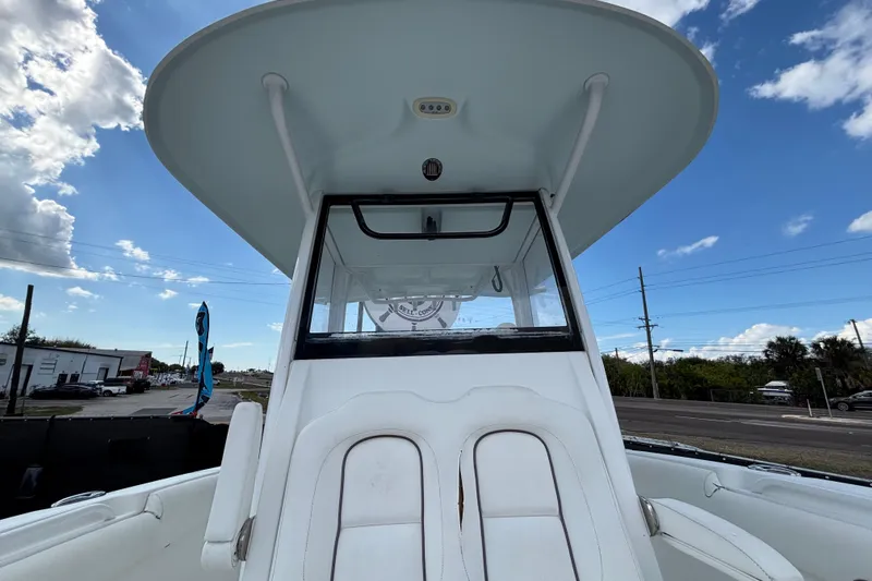 Slide: The Image of 2018 Sea Hunt Gamefish 30 Forward Seating boat, showcasing helm and seating area under clear sky. - 105