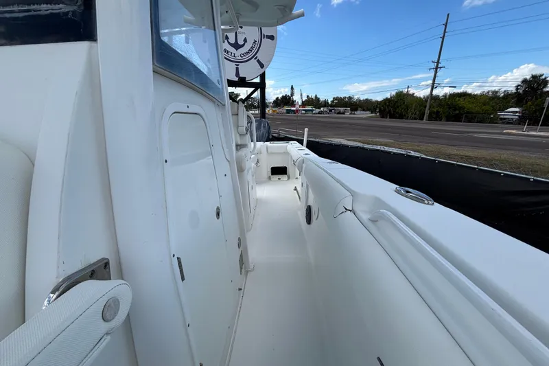 Slide: The Image of 2018 Sea Hunt Gamefish 30 boat with forward seating, white interior, and clear sky background. - 113