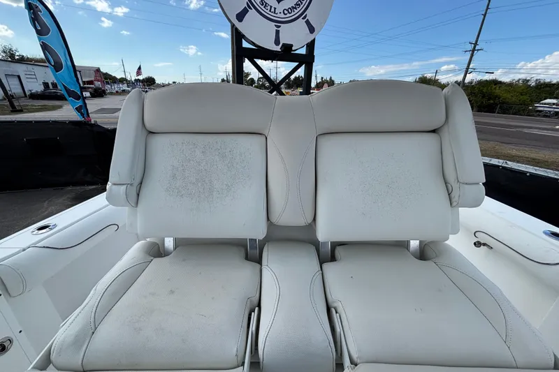 Slide: The Image of 2018 Sea Hunt Gamefish 30 boat with forward seating, featuring white cushioned seats. - 117