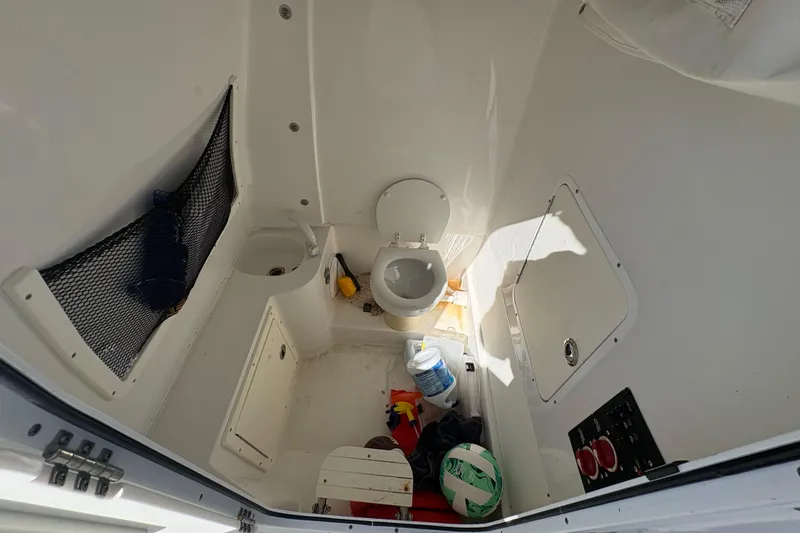 Slide: The Image of 2018 Sea Hunt Gamefish 30 boat with forward seating, docked on a sunny day. - 12