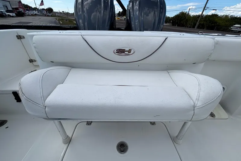 Slide: The Image of 2018 Sea Hunt Gamefish 30 Forward Seating, white cushioned bench, outdoor setting. - 124