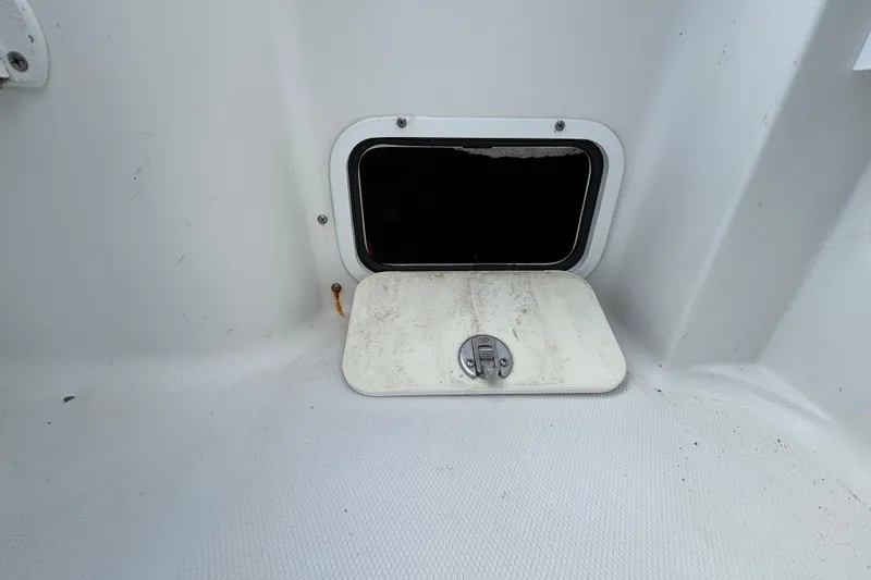 Slide: The Image of 2018 Sea Hunt Gamefish 30 storage compartment with open hatch, white interior. - 126