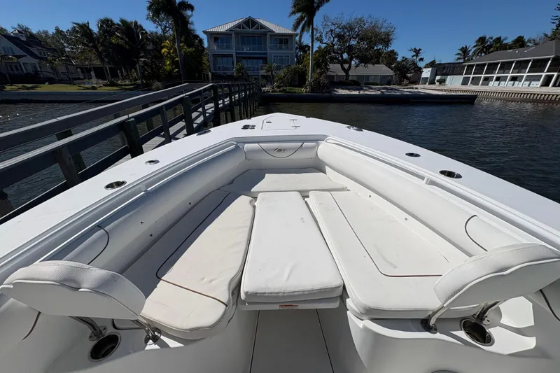 Slide: The Image of 2018 Sea Hunt Gamefish 30 boat with forward seating, docked by the water. - 14
