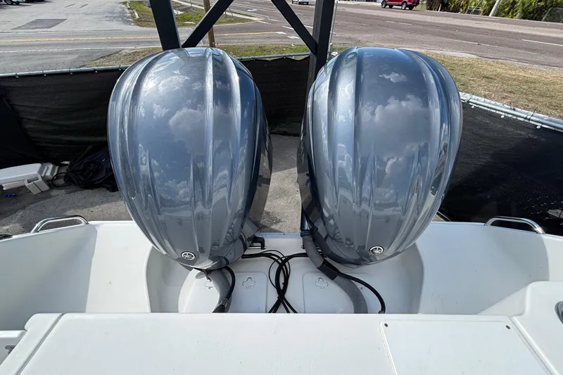 Slide: The Image of 2018 Sea Hunt Gamefish 30 with dual outboard motors, parked on a trailer. - 143