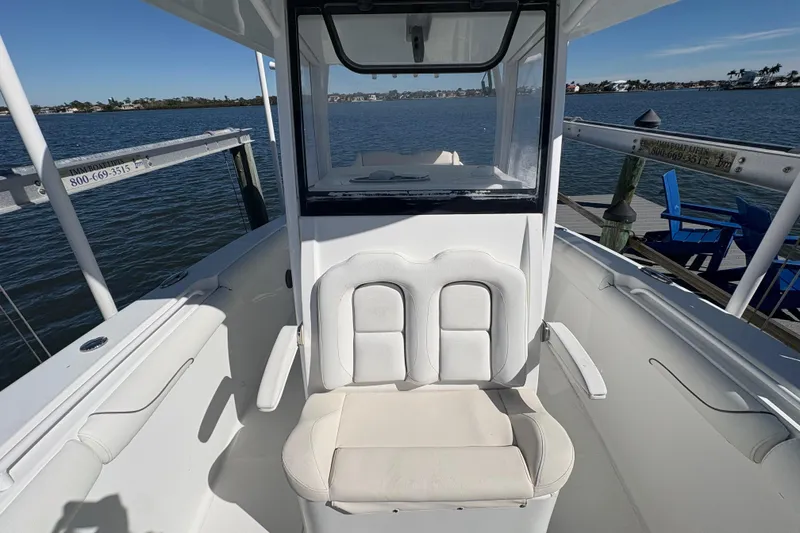 Slide: The Image of 2018 Sea Hunt Gamefish 30 boat with dual engines docked by a serene lake. - 19