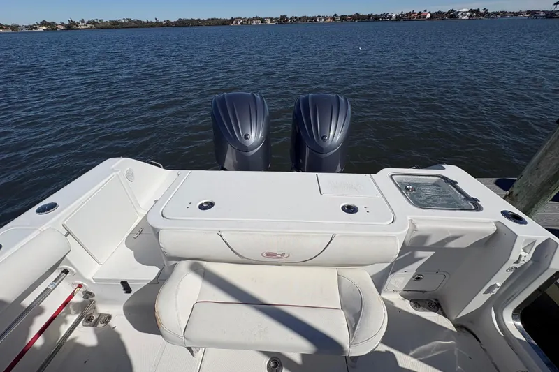 Slide: The Image of 2018 Sea Hunt Gamefish 30 boat docked, featuring forward seating and modern controls. - 2