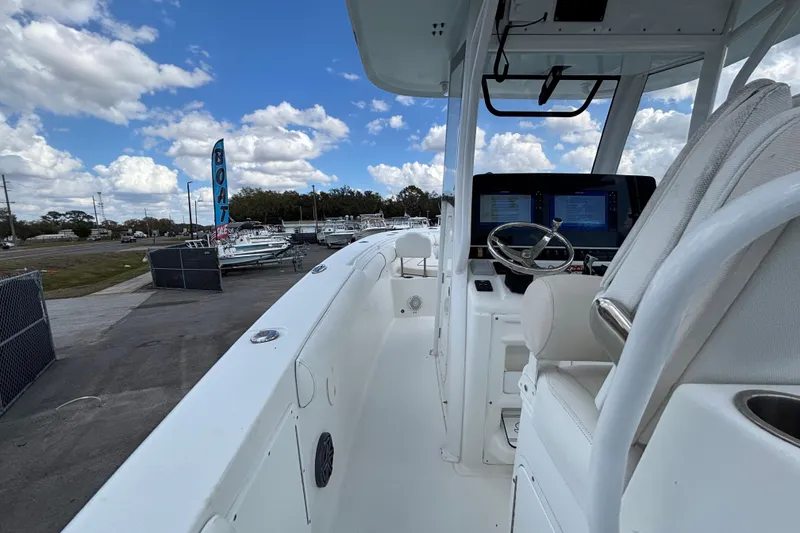 Slide: The Image of 2018 Sea Hunt Gamefish 30 boat with forward seating, displayed at a boat dealership. - 30