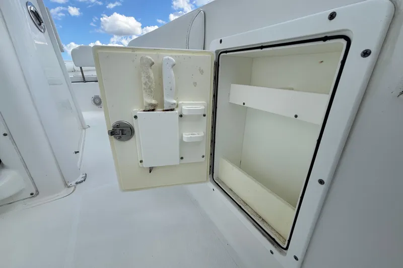 Slide: The Image of 2018 Sea Hunt Gamefish 30 storage compartment with open door and knife holders. - 34