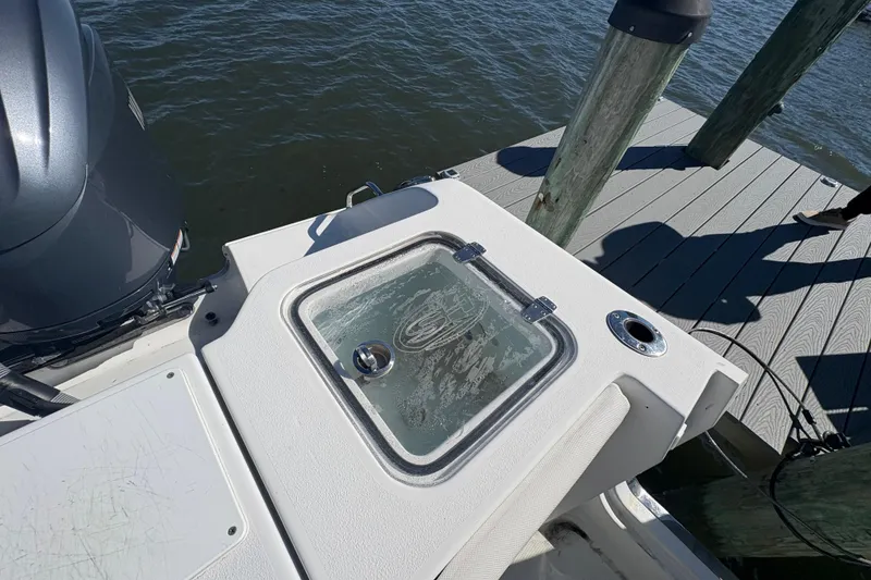 Slide: The Image of 2018 Sea Hunt Gamefish 30 boat interior with forward seating, docked by waterfront homes. - 4