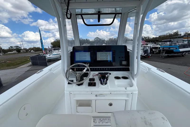 Slide: The Image of 2018 Sea Hunt Gamefish 30 boat cockpit with steering wheel and navigation screens. - 41