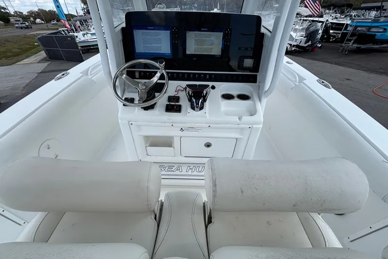 Slide: The Image of 2018 Sea Hunt Gamefish 30 boat cockpit with dual screens and steering wheel. - 43