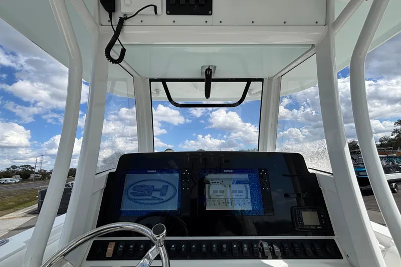 Slide: The Image of 2018 Sea Hunt Gamefish 30 dashboard with navigation display under a blue sky. - 46