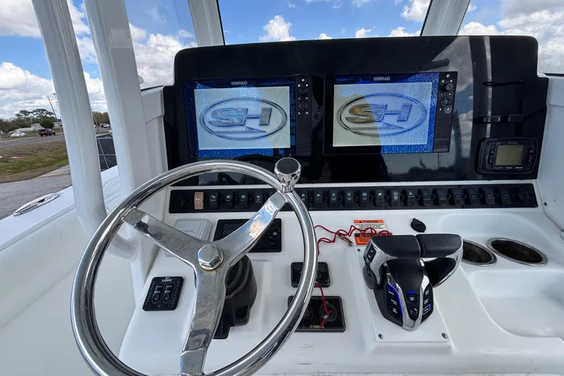 Slide: The Image of 2018 Sea Hunt Gamefish 30 helm with dual Simrad displays and steering wheel. - 48