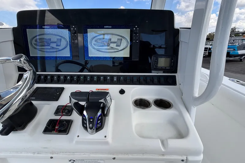 Slide: The Image of 2018 Sea Hunt Gamefish 30 dashboard with dual Simrad displays and controls. - 50