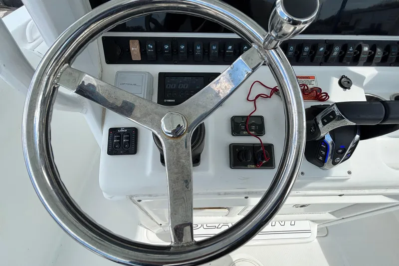 Slide: The Image of Steering wheel and controls of 2018 Sea Hunt Gamefish 30 boat cockpit. - 53