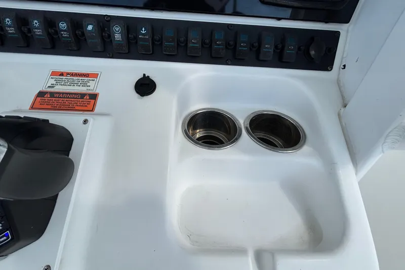 Slide: The Image of Control panel of 2018 Sea Hunt Gamefish 30 with cup holders and warning labels. - 59