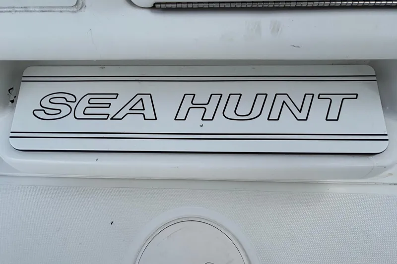 Slide: The Image of 2018 Sea Hunt Gamefish 30 Forward Seating boat logo on white surface. - 66