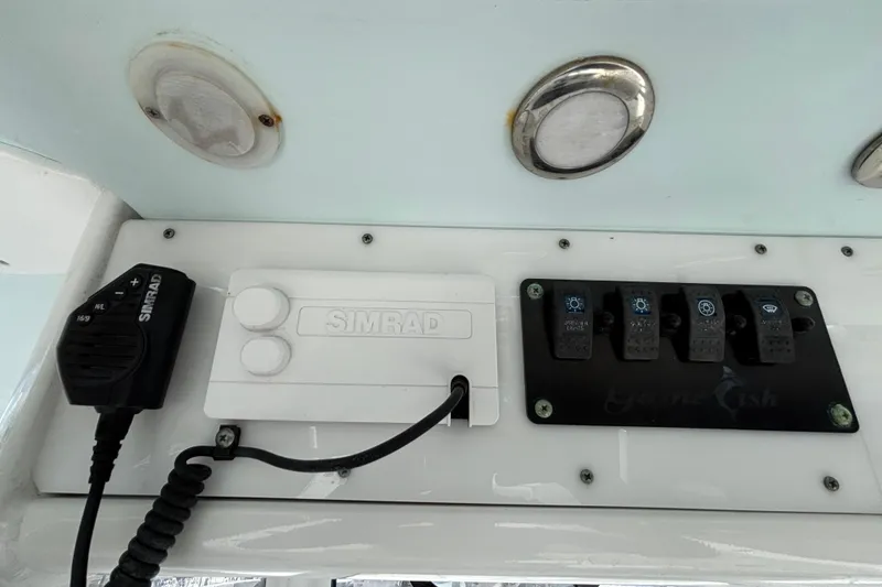 Slide: The Image of 2018 Sea Hunt Gamefish 30 control panel with Simrad electronics and switches. - 69