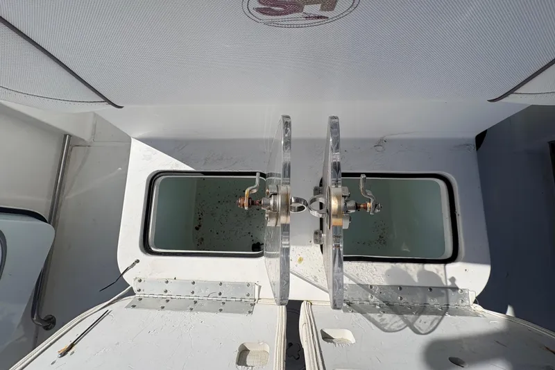 Slide: The Image of Interior of 2018 Sea Hunt Gamefish 30 boat bathroom with toilet and storage. - 7