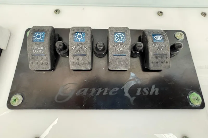 Slide: The Image of Control panel of a 2018 Sea Hunt Gamefish 30 boat with labeled switches. - 70