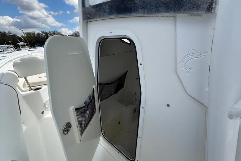 Slide: The Image of 2018 Sea Hunt Gamefish 30 Forward Seating boat interior with open storage compartment. - 72