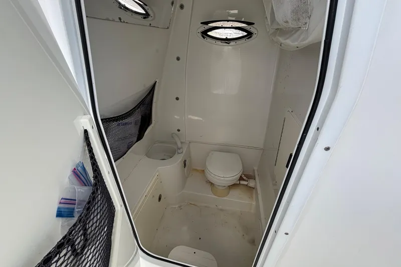 Slide: The Image of 2018 Sea Hunt Gamefish 30 boat interior bathroom with toilet and storage. - 73