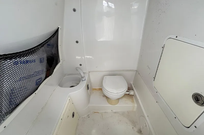 Slide: The Image of 2018 Sea Hunt Gamefish 30 boat interior with toilet and sink. - 74