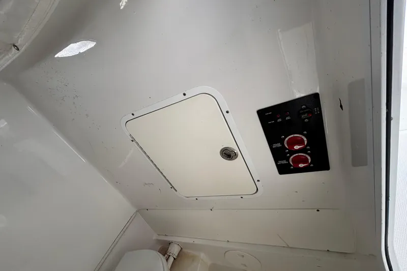 Slide: The Image of 2018 Sea Hunt Gamefish 30 interior with control panel and storage compartment. - 75