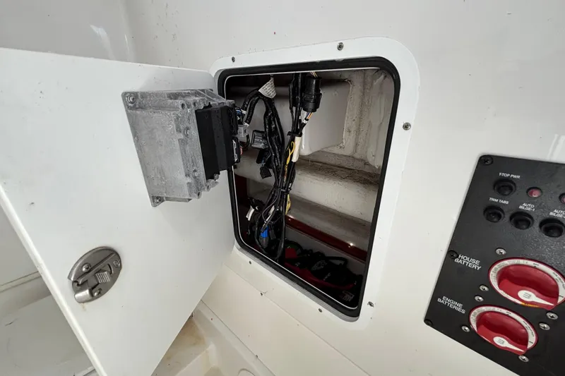 Slide: The Image of Open electrical panel on 2018 Sea Hunt Gamefish 30 boat, showing wiring and controls. - 77