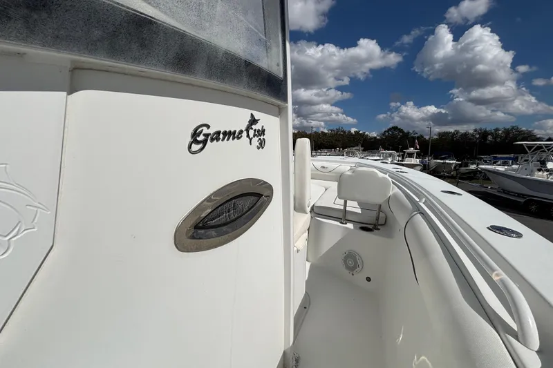 Slide: The Image of 2018 Sea Hunt Gamefish 30 boat with forward seating under a cloudy sky. - 79
