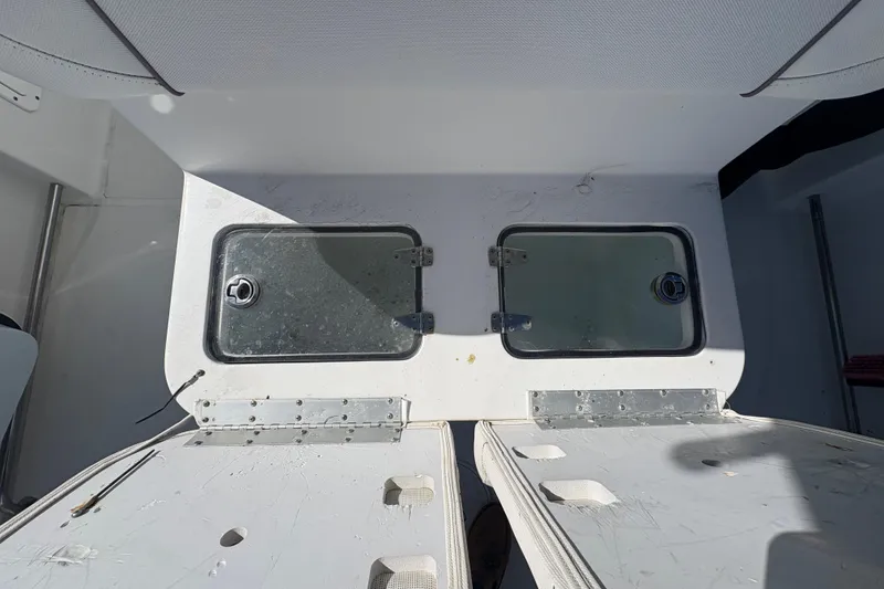 Slide: The Image of 2018 Sea Hunt Gamefish 30 Forward Seating boat docked by waterfront homes. - 8