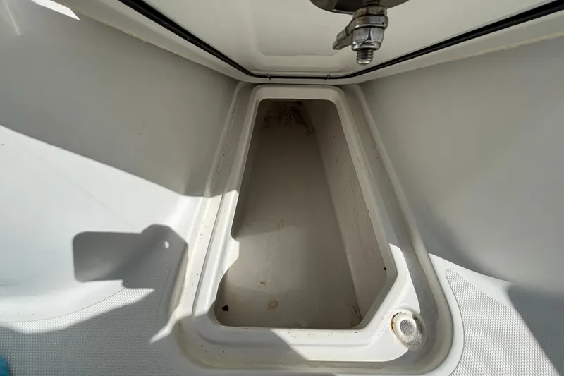 Slide: The Image of 2018 Sea Hunt Gamefish 30 Forward Seating storage compartment, open and empty. - 86