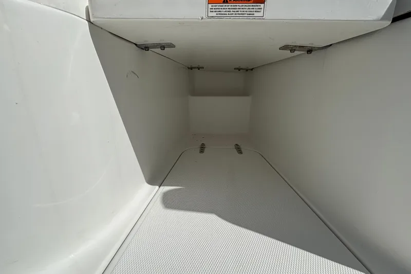 Slide: The Image of 2018 Sea Hunt Gamefish 30 Forward Seating storage compartment, white interior, open hatch. - 88