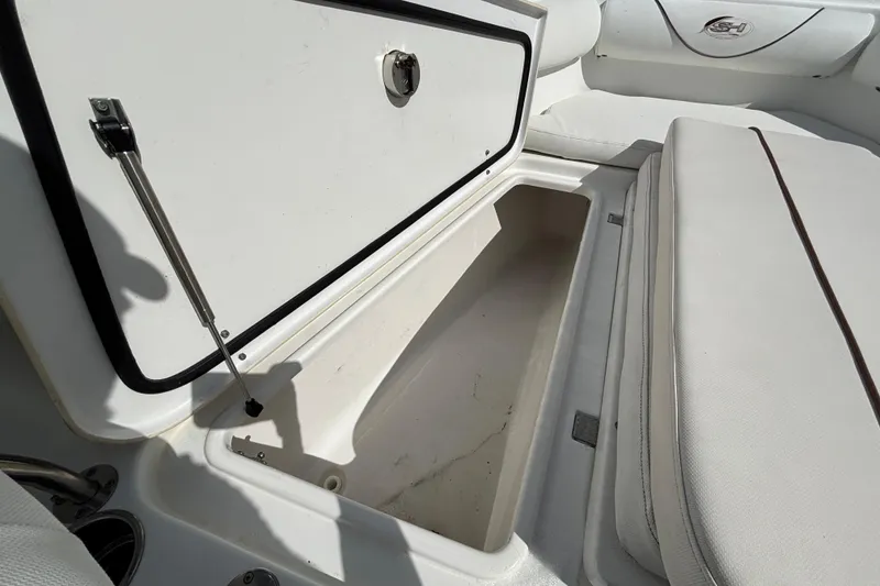 Slide: The Image of 2018 Sea Hunt Gamefish 30 Forward Seating storage compartment open, showcasing interior space. - 89