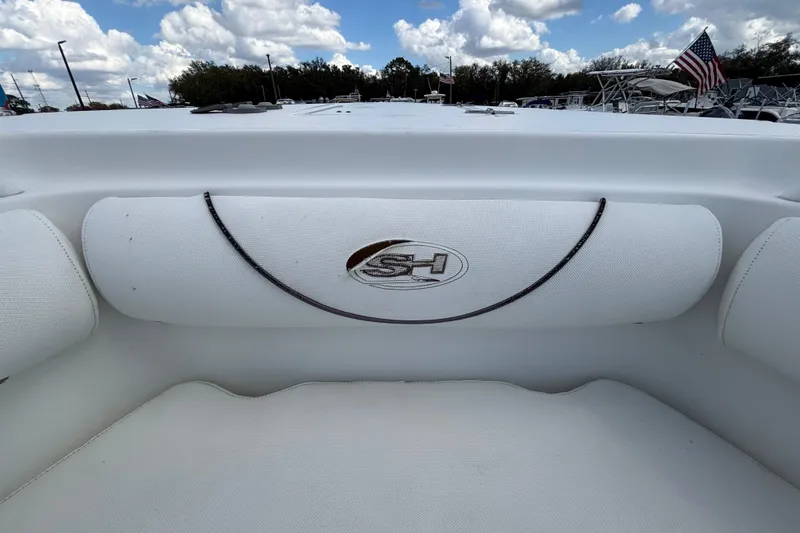 Slide: The Image of 2018 Sea Hunt Gamefish 30 Forward Seating, white interior, logo detail, under cloudy sky. - 94