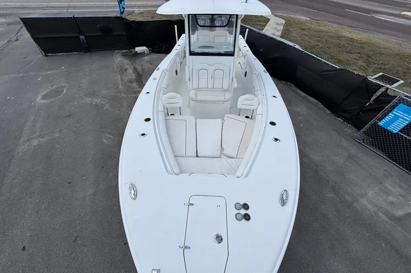 Slide: The Image of 2018 Sea Hunt Gamefish 30 Forward Seating boat, aerial view, docked on pavement. - 99