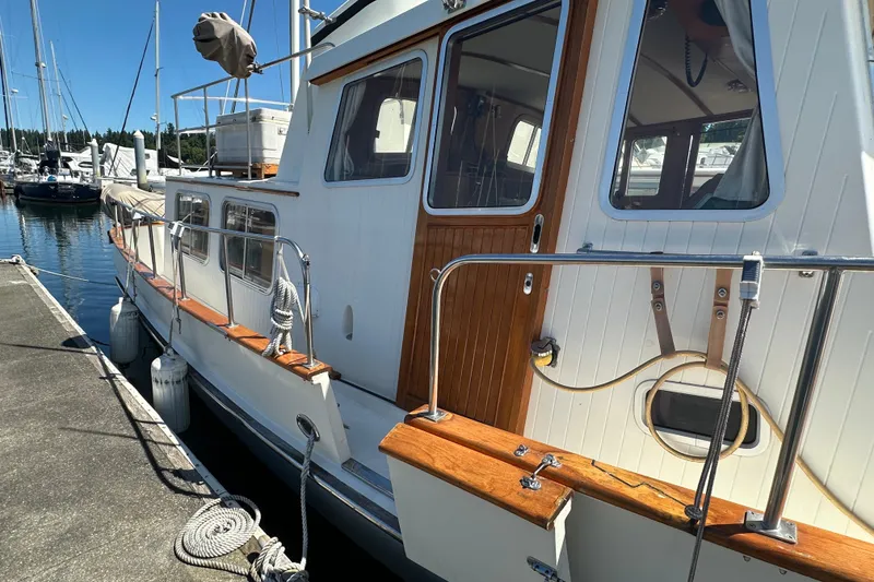 Slide: The Image of Eagle 40 Pilothouse Trawler 2000 docked, showcasing wooden accents and sleek design. - 2