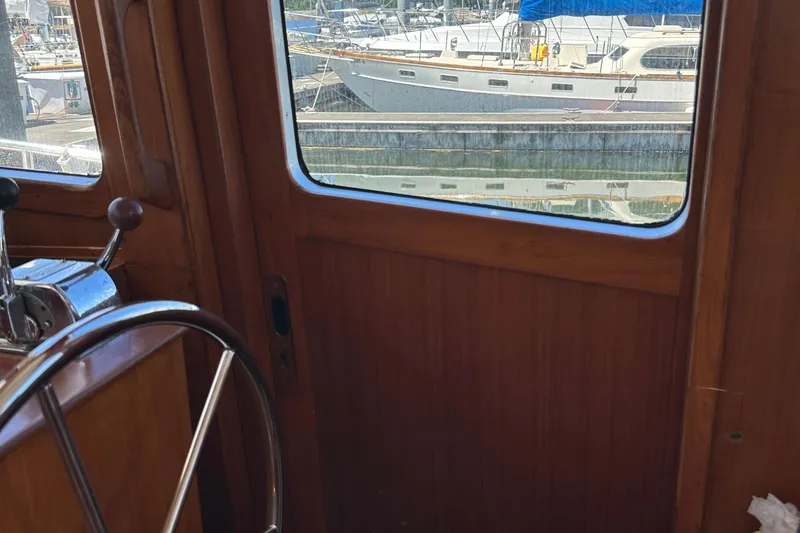 Slide: The Image of Interior view of 2000 Eagle 40 Pilothouse Trawler with marina in background. - 35