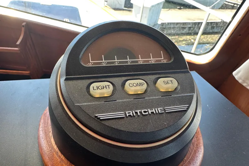 Slide: The Image of Compass on 2000 Eagle 40 Pilothouse Trawler dashboard with light, comp, set buttons. - 36