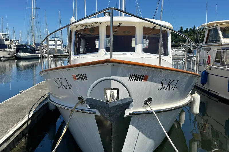 Slide: The Image of 2000 Eagle 40 Pilothouse Trawler docked in a marina, surrounded by other boats. - 4