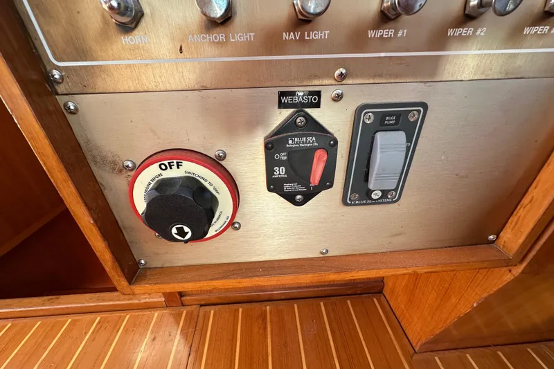 Slide: The Image of Control panel of a 2000 Eagle 40 Pilothouse Trawler with switches and dials. - 49