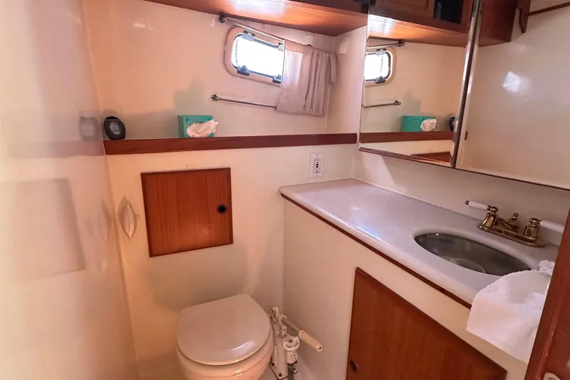 Slide: The Image of Bathroom interior of 2000 Eagle 40 Pilothouse Trawler with sink, toilet, and mirror. - 55