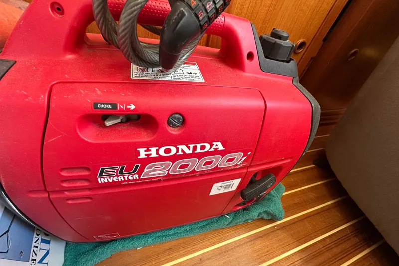 Slide: The Image of Red Honda EU2000i inverter generator on a wooden floor of a 2000 Eagle 40 Pilothouse Trawler. - 70