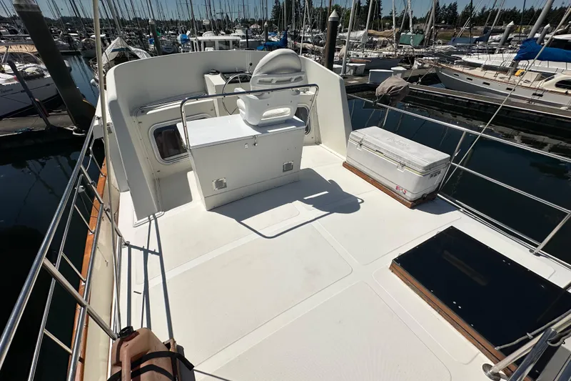 Slide: The Image of Eagle 40 Pilothouse Trawler 2000 model, spacious deck with seating, docked at marina. - 8