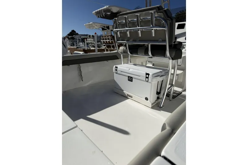 Slide: The Image of 2026 Key West 239 FS boat interior with seating and cooler, showcasing sleek design. - 2