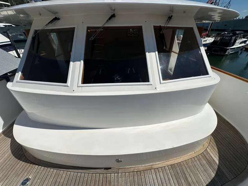 Slide: The Image of 1985 Ocean Alexander Pilothouse yacht with large windows and wooden deck. - 11
