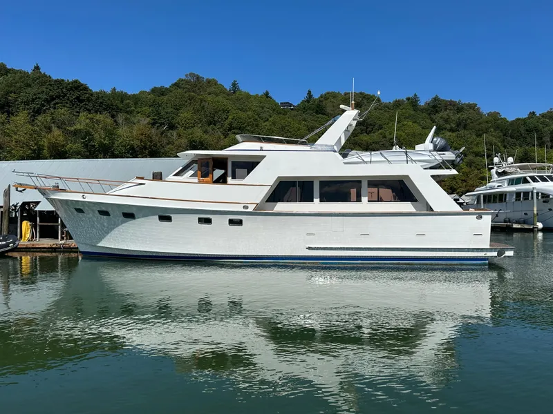The Image of 1985 Ocean Alexander Pilothouse yacht docked in a serene marina setting. - 0