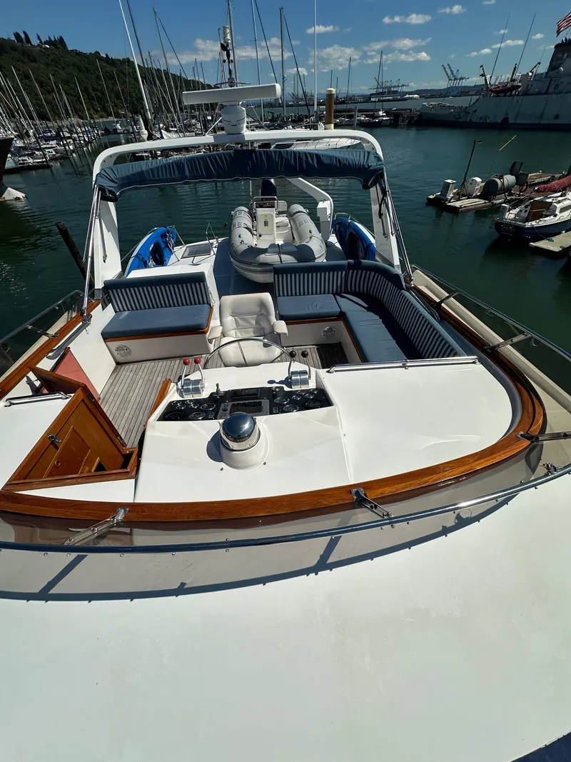 Slide: The Image of 1985 Ocean Alexander Pilothouse yacht with spacious deck and seating, docked in a marina. - 21