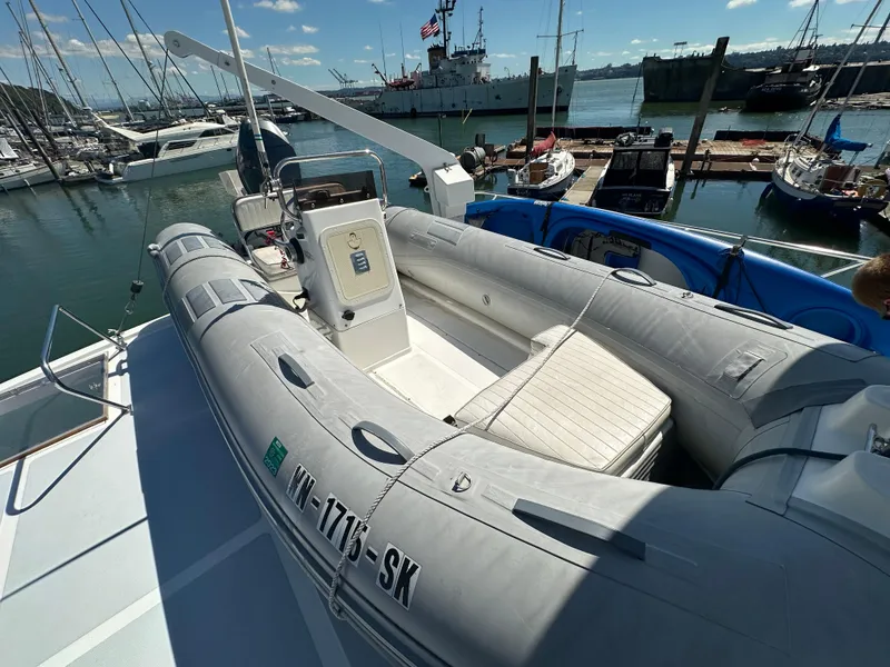 Slide: The Image of 1985 Ocean Alexander Pilothouse with inflatable boat on deck, docked at marina. - 27